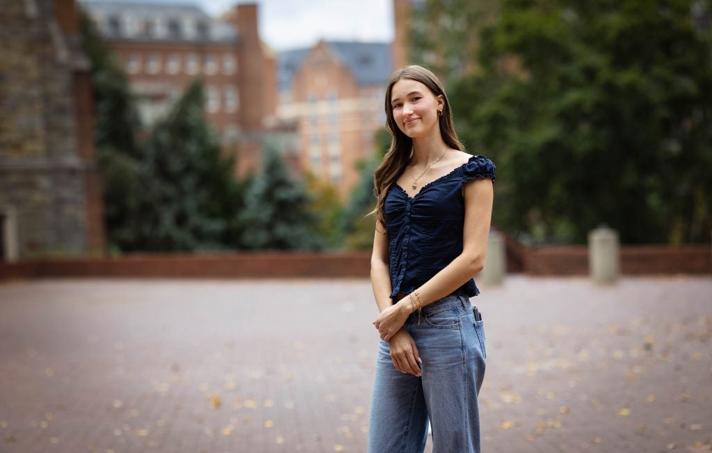 Zoe in a blue blouse on GU campus