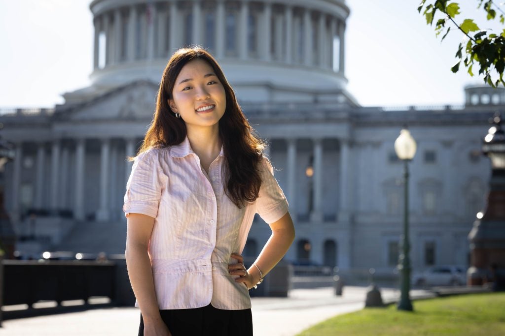 Ashley in a pink blouse in front of the US Capitol