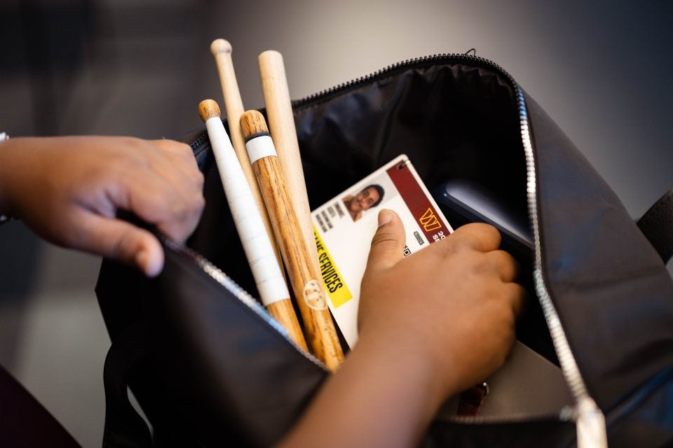 Drumsticks in a bag with an ID card