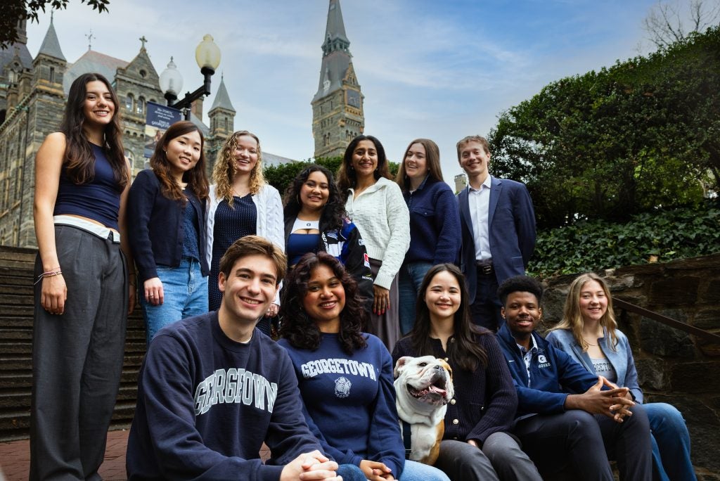 GU Stories cast on Lauinger Steps with Healy Hall in the background