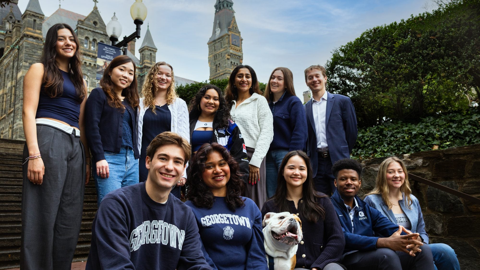 GU Stories cast on Lauinger Steps with Healy Hall in the background