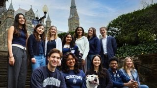 GU Stories cast on Lauinger Steps with Healy Hall in the background