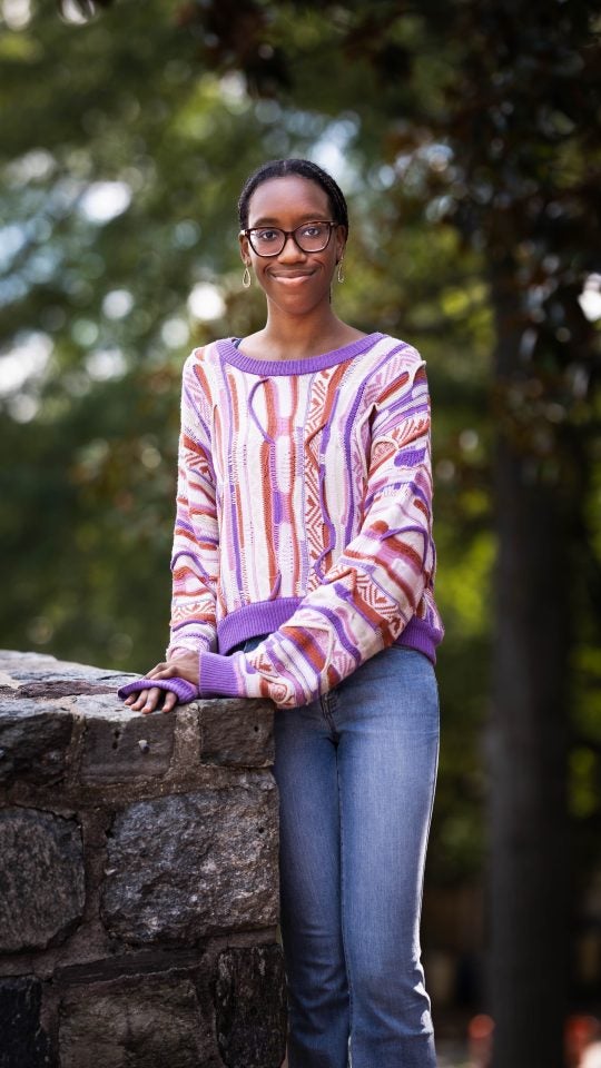 Yasmin in a purple sweater outside