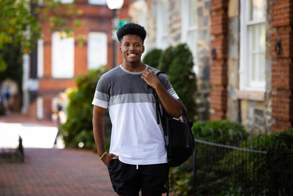 Justin in a white t shirt with a backpack in the Georgetown neighborhood
