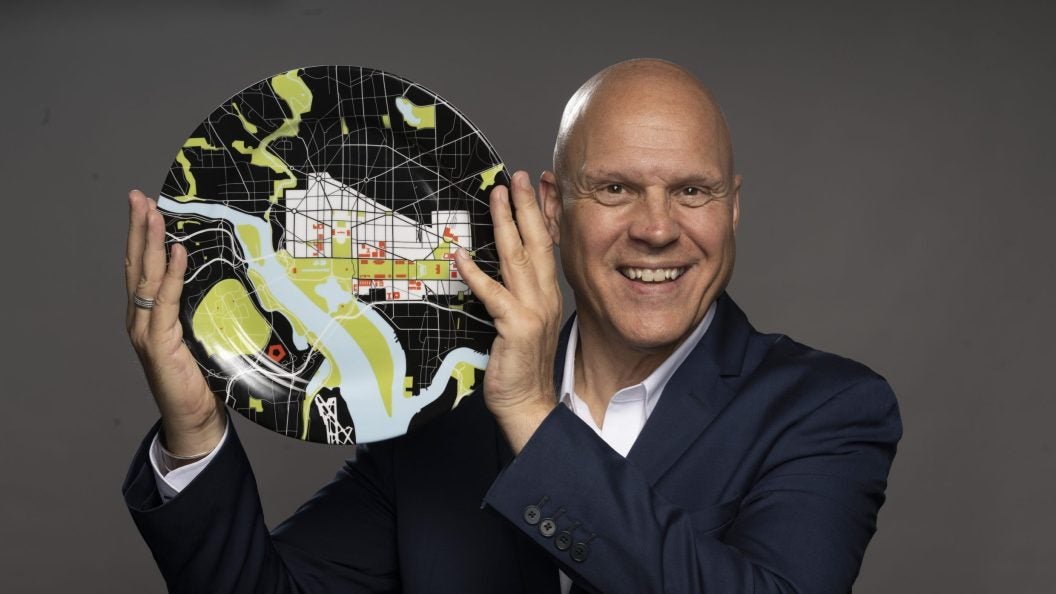 Former Washington Post Food Critic Tom Sietsema poses with a plate in revealing his face to readers for the first time after being undercover