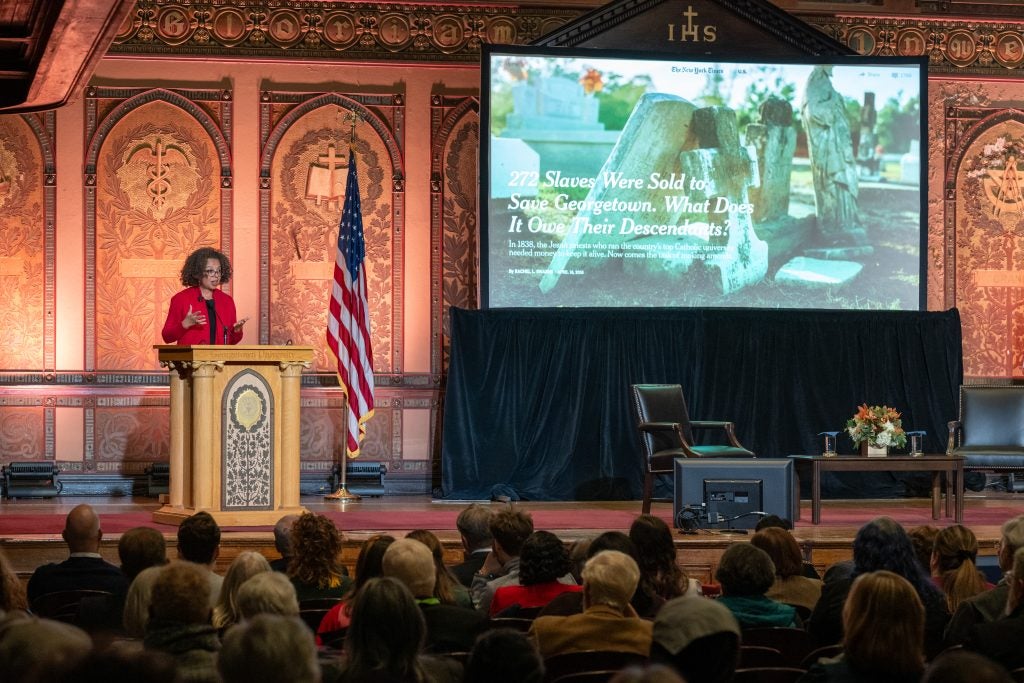 A presentation in Gaston Hall with a woman at a podium