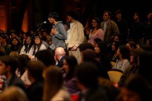 Students line up to ask questions in Gaston Hall