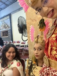 Young woman with two women in traditional Indonesian clothing