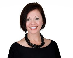 Portrait of Adrea Turner, a caucasian woman with short brown hair wearing a necklace and black blouse
