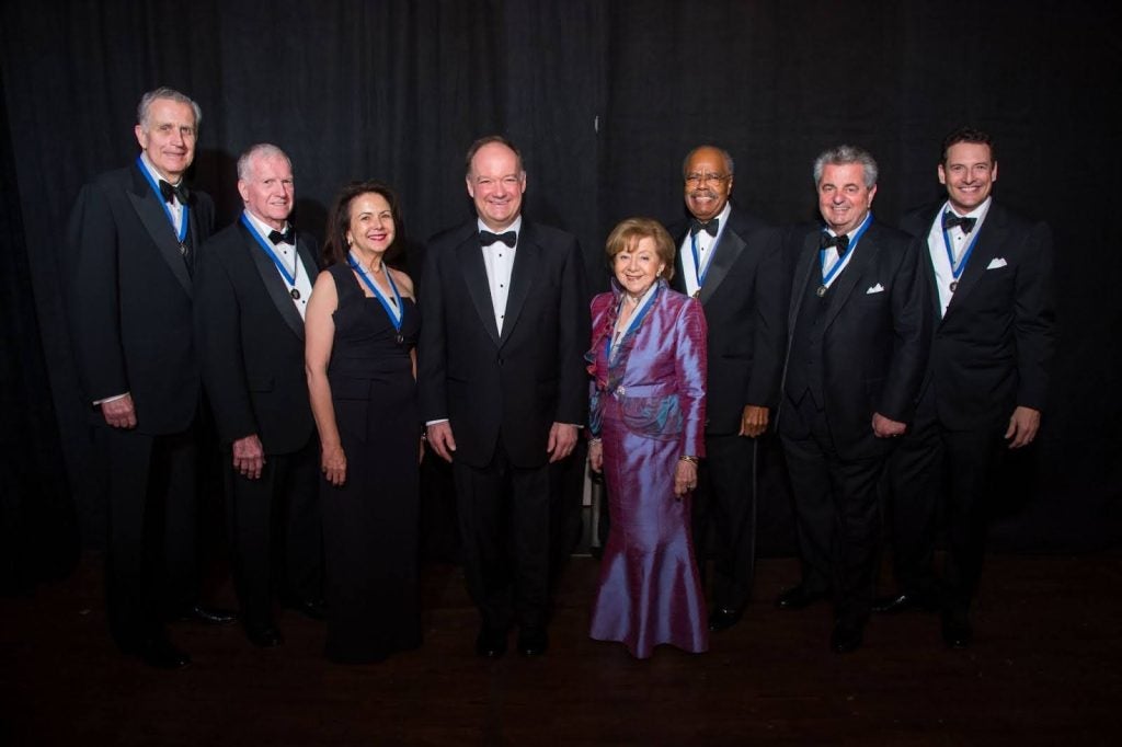 Tagliabue posing with a group at the John Carroll Awards in 2015.