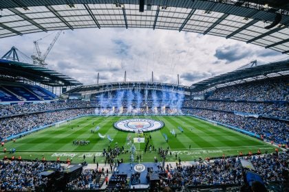 General view inside the stadium as a giant Manchester City crest is displayed on the pitch as blue flares and pyrotechnics are set off ahead of the Premier League match between Manchester City and Tottenham Hotspur at the Etihad Stadium, Manchester, England. Saturday 23rd August 2025. (Photo by Isaac Parkin/Manchester City FC)