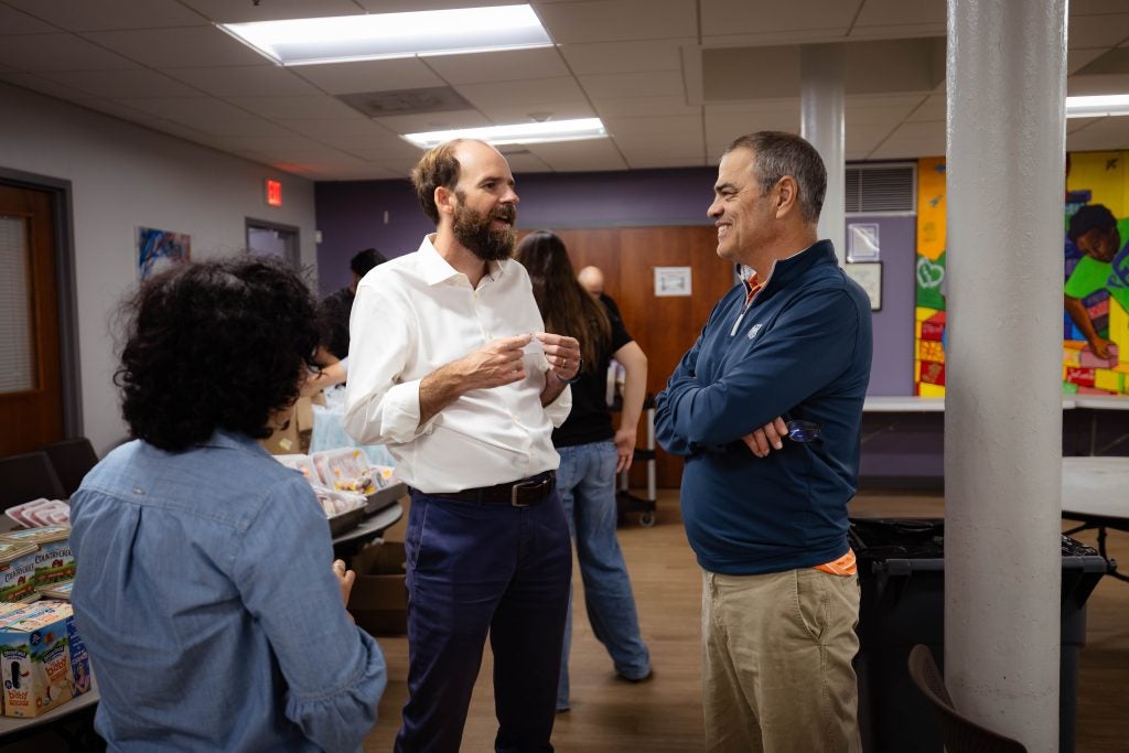 Two men talk to each other inside a food pantry in DC