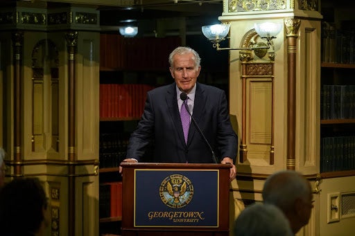 Paul Tagliabue standing at a Georgetown podium.
