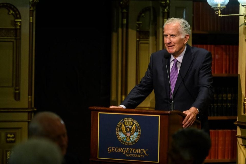Paul Tagliabue standing at a Georgetown podium.