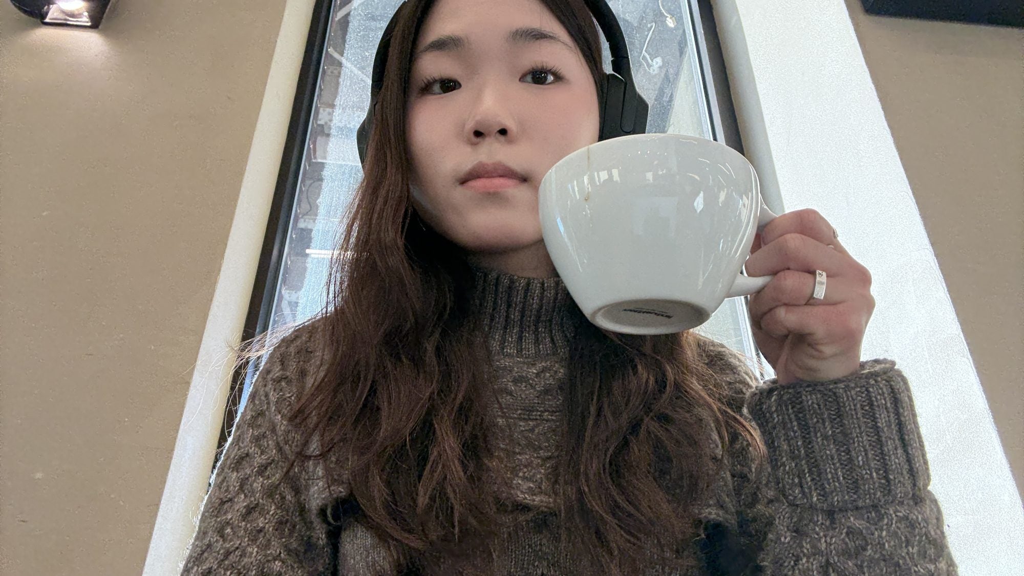 Young Asian woman holding a cup of coffee