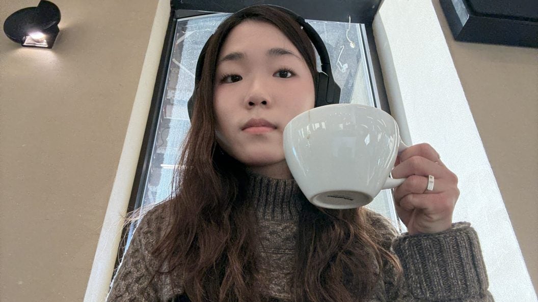 Young Asian woman holding a cup of coffee