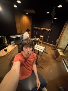 A young man in a recording studio