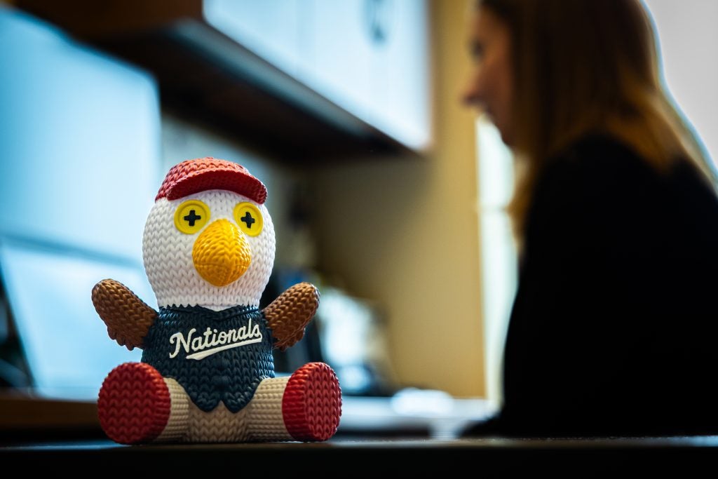 A knitted eagle mascot of the Nationals baseball team sits on a desk