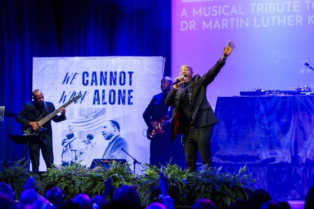 A Black man performs on stage