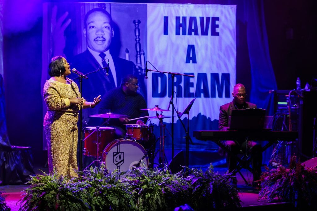 A Black woman performs on stage
