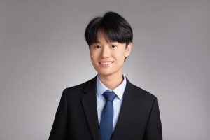 Young Asian man in a suit and tie smiling