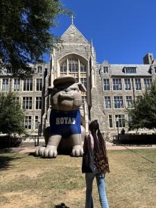 Young Black woman looks at an inflatable of Jack the Bulldog
