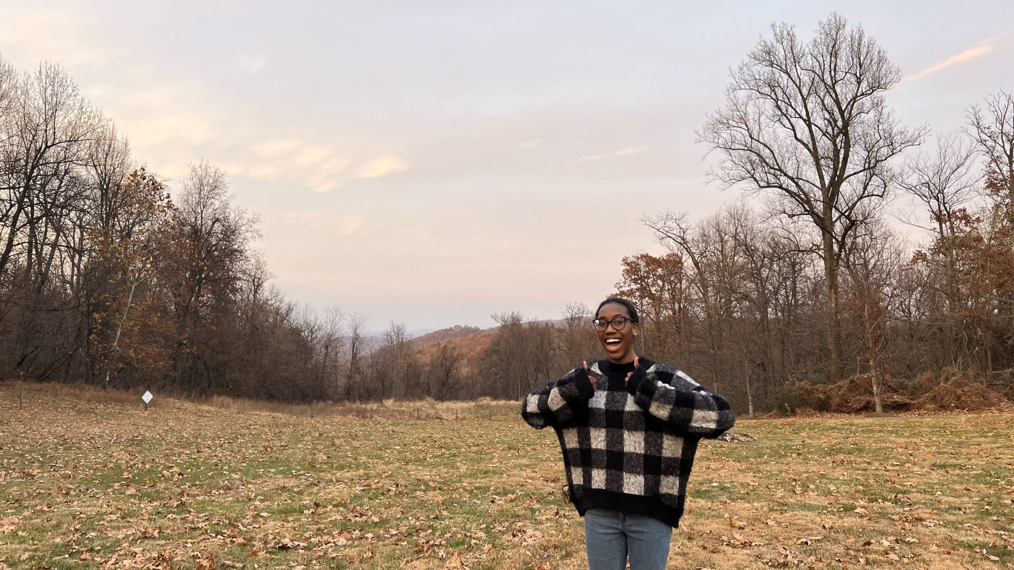 Young Black woman with two thumbs up
