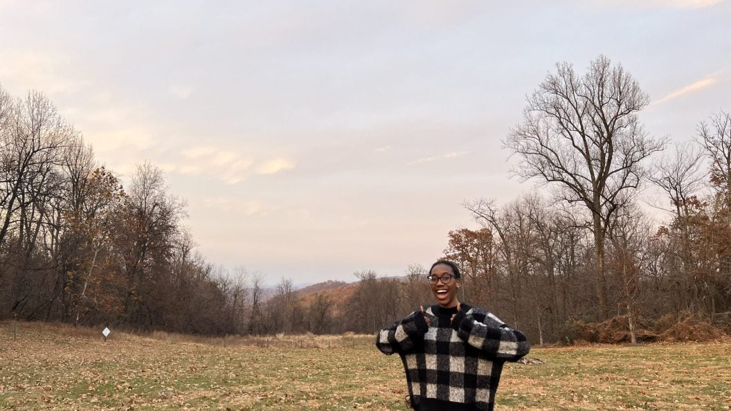 Young Black woman with two thumbs up
