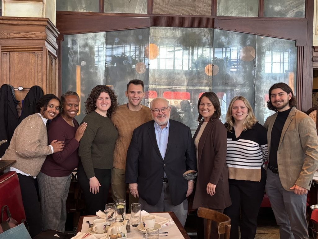 A group of people gather together at a restaurant