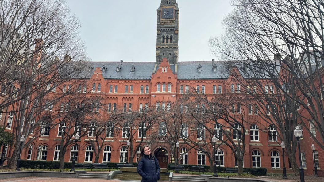 Young Caucasian woman in the winter behind Healy Haall