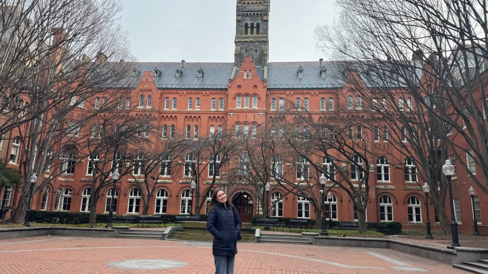 Young Caucasian woman in the winter behind Healy Haall