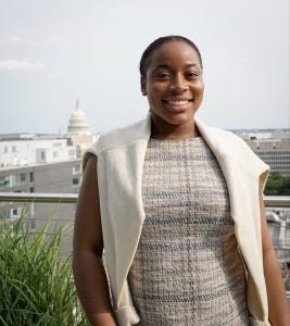 Young Black woman smiling with Capitol in the background