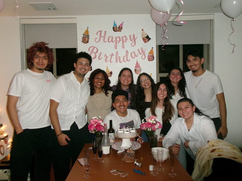 Group of students with a happy birthday banner