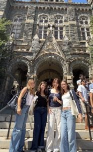 A group of young women in front of Healy Hall on a sunny day