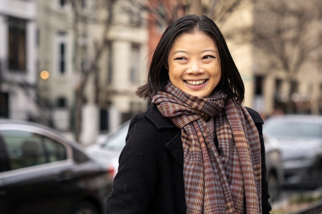 Young Asian woman smiling wearing winter clothes and a scarf