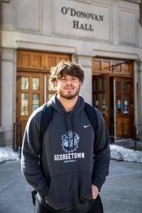 Young man wearing a GU football sweatshirt on a sunny day