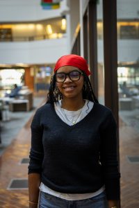 Young Black female student wearing a red head covering indoors