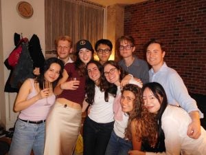 A group of students smiling indoors