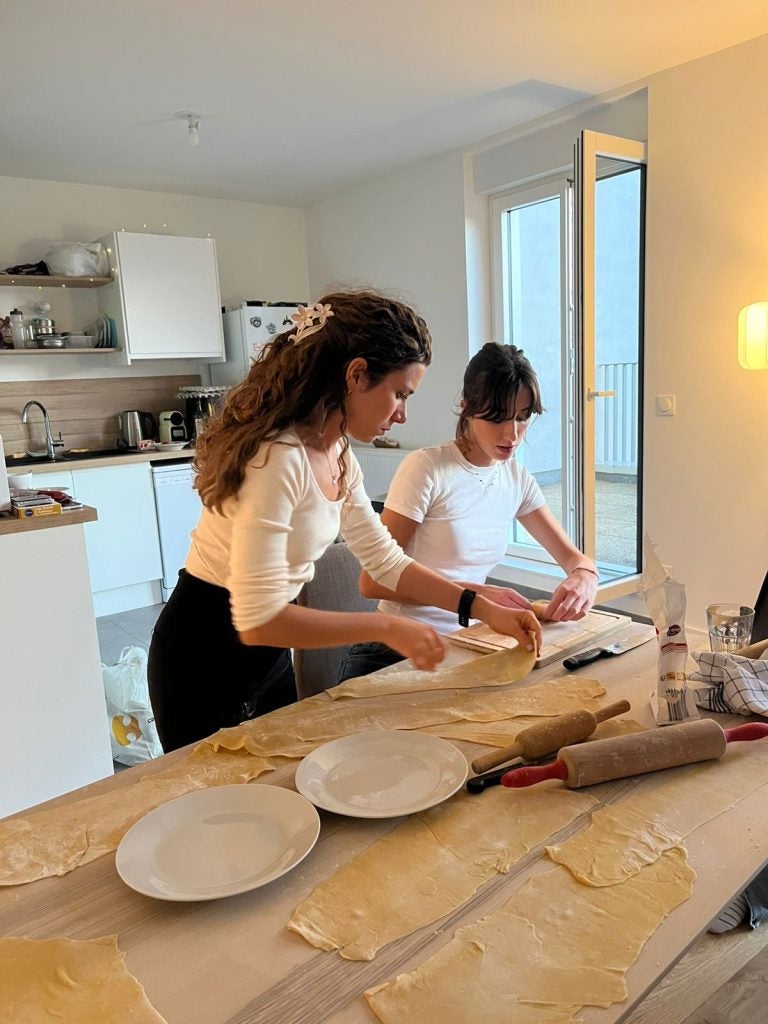Two young women cook together