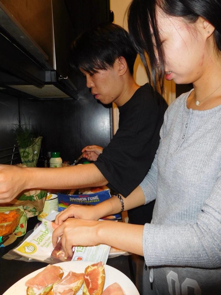 Two students cooking together