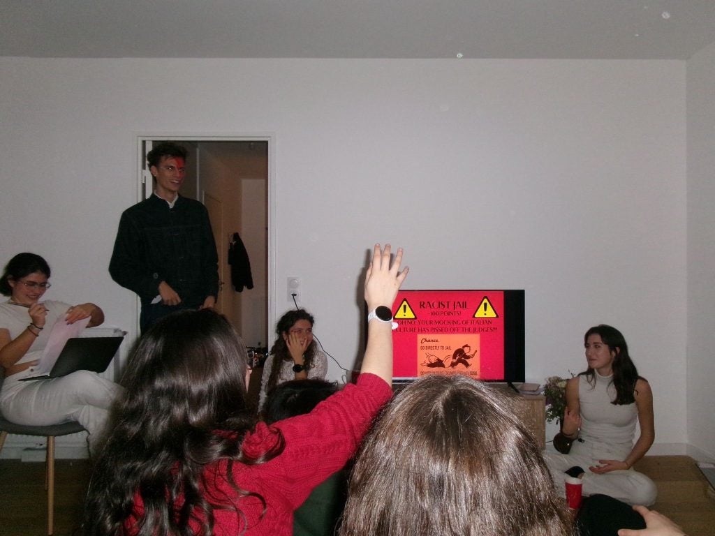A group of students around a TV screen