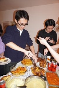 A students gets food from a plate