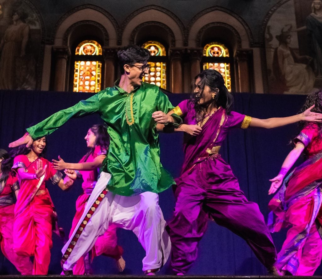 Two students perform a dance at a South Asian showcase. 