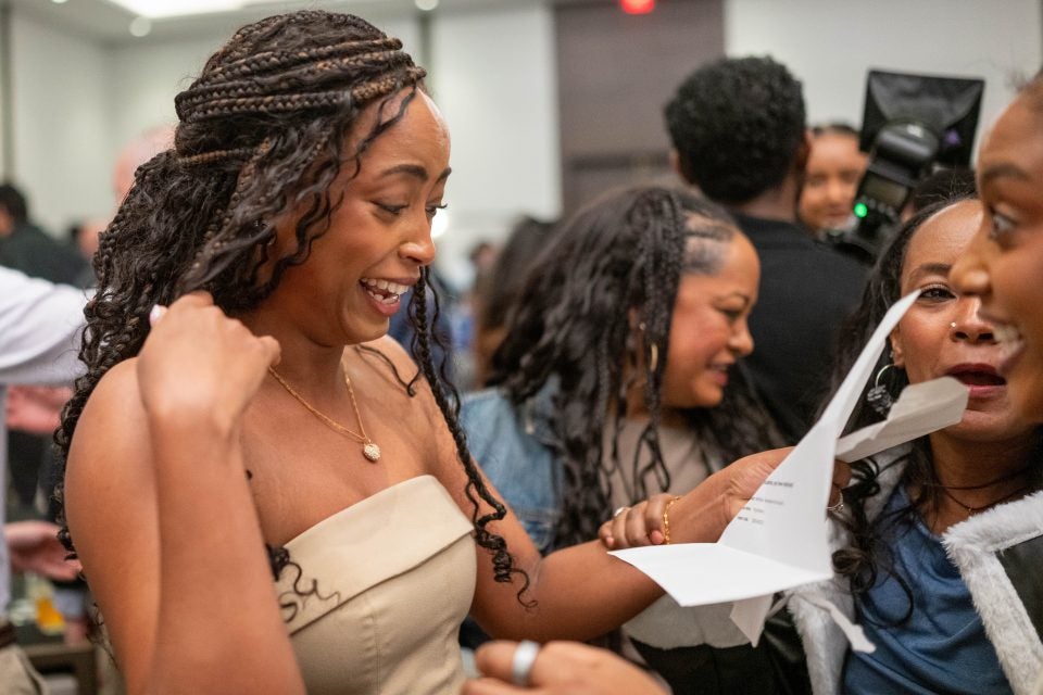 A medical student reads a letter and smiles