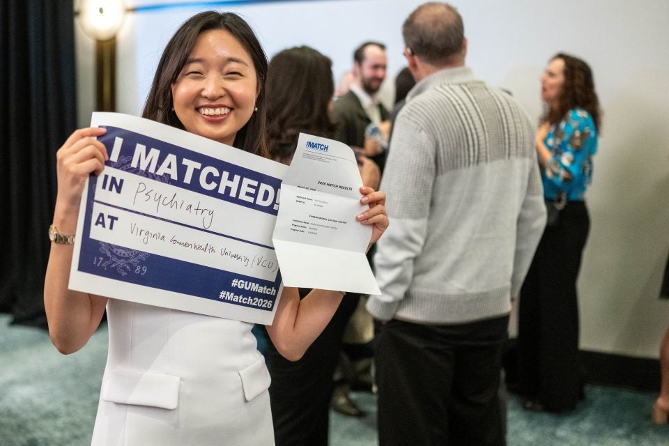 A medical student holds up a "I Matched!" sign