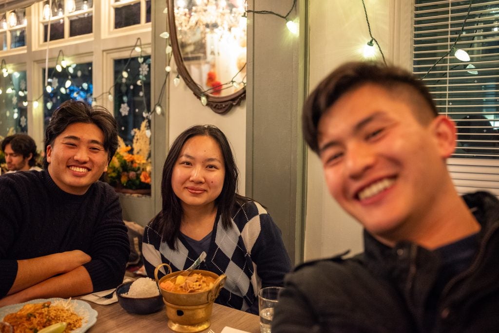Three young Asian adults at dinner