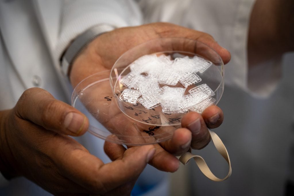 A container filled with white 3d printer bone scaffolds