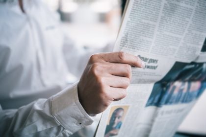 Midsection Of Businessman Reading Newspaper