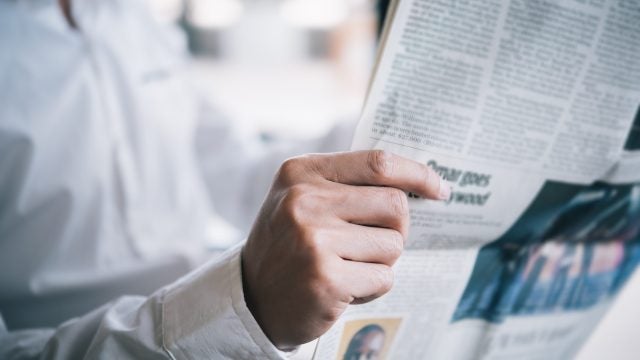 Midsection Of Businessman Reading Newspaper