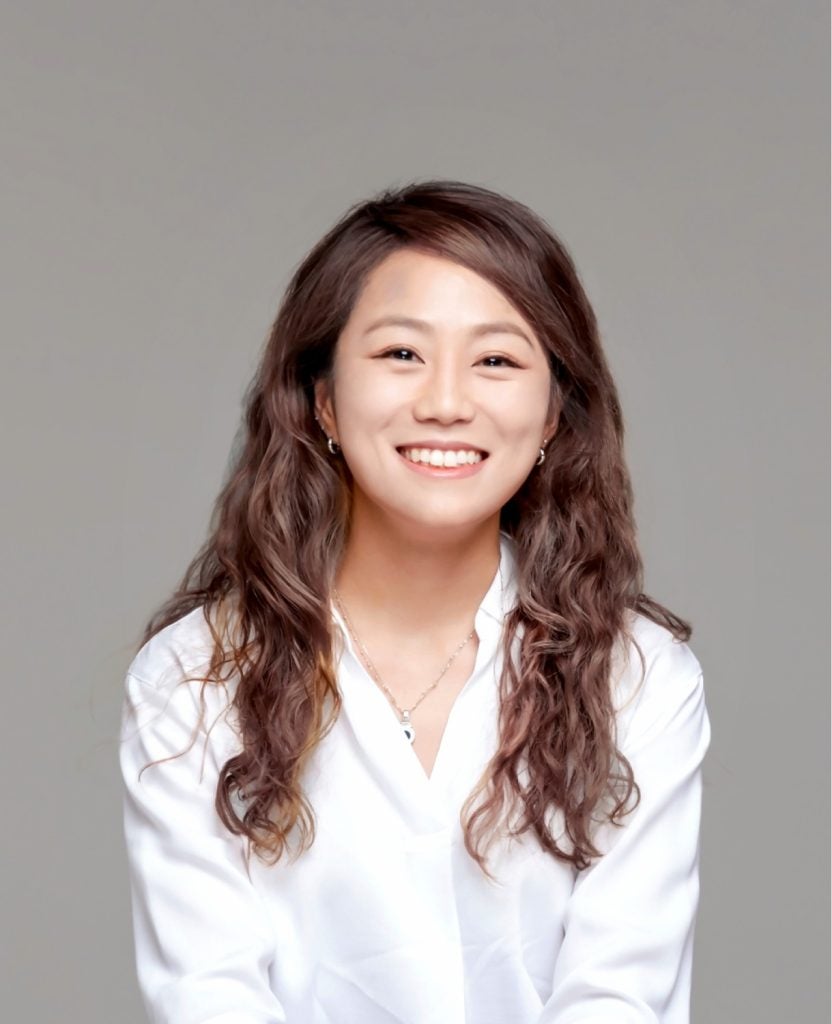 Smiling Asian woman in a white blouse